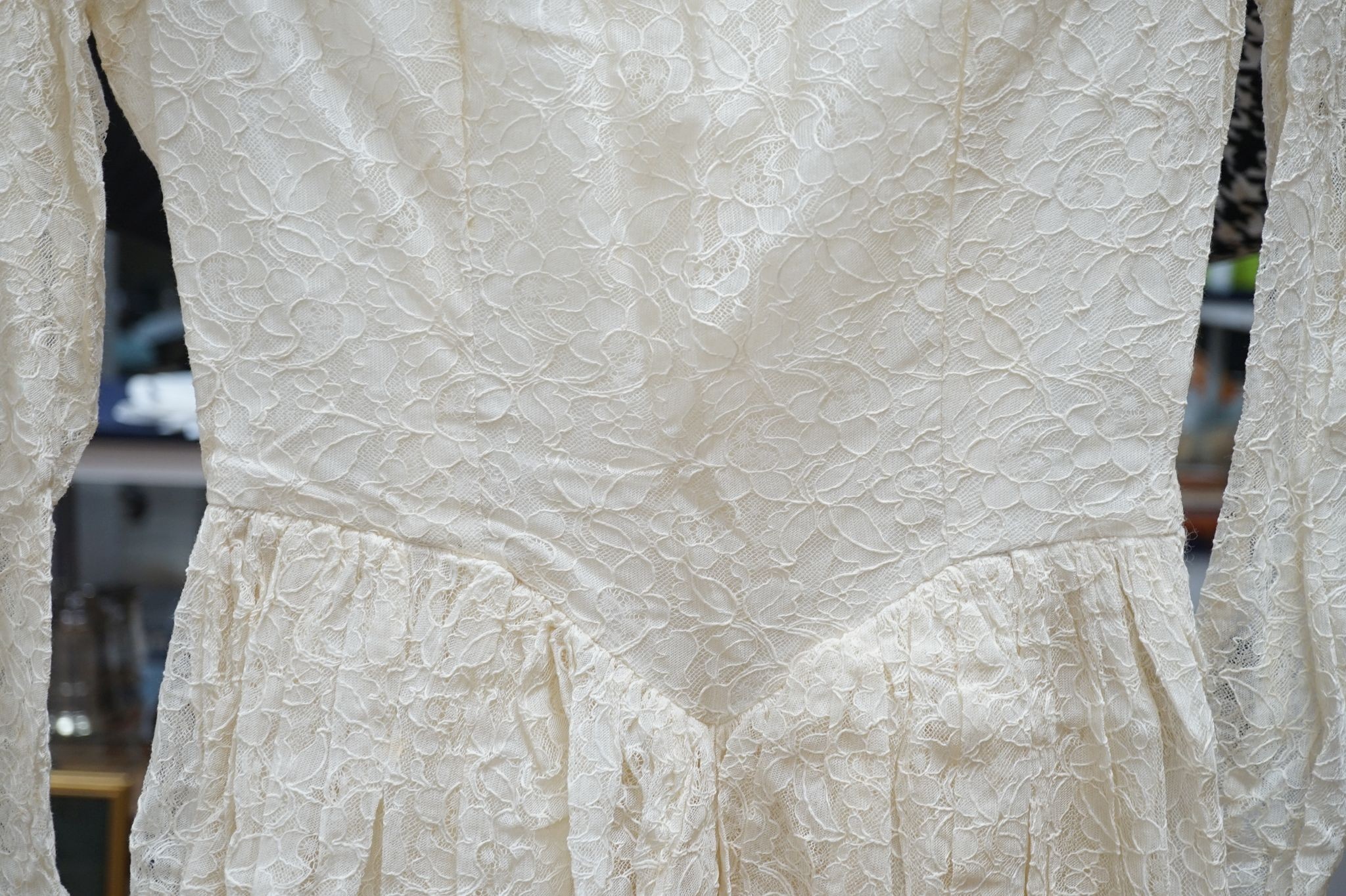 A late 1930's- 40's cream machine lace wedding dress and petticoat together with a pear listed floral tiara/ headdress.